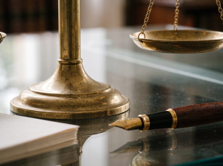 Scale_of_justice_on_desk_202608202142